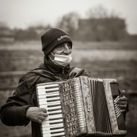 grayscale photo of man playing piano